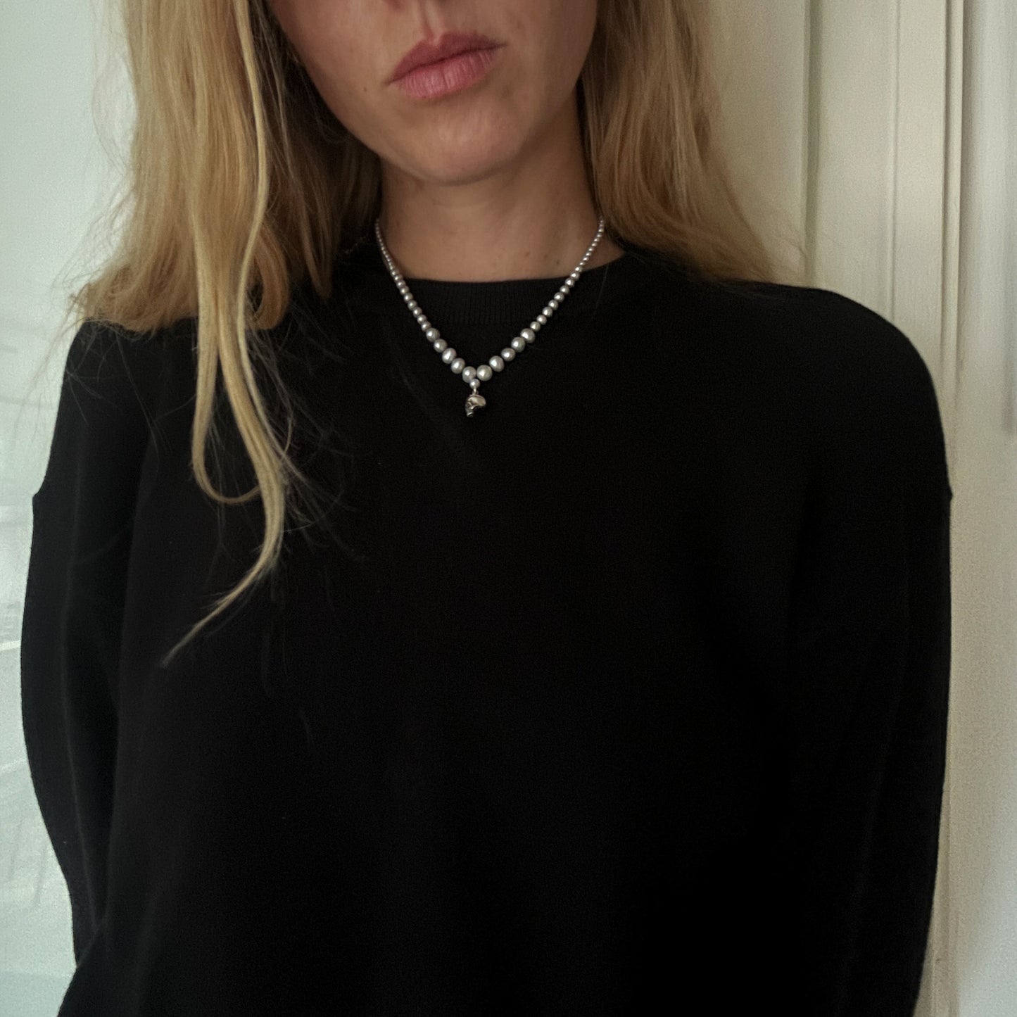 Hand strung grey freshwater pearls with a medium sterling silver skull, made by hand in London by Charlie Shires