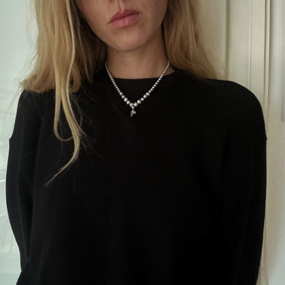 Hand strung grey freshwater pearls with a medium sterling silver skull, made by hand in London by Charlie Shires