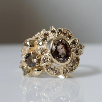 The Helen engagement ring with colour change sapphire, champagne diamond with skulls and flowers made in 9ct yellow gold in London by Charlie Shires
