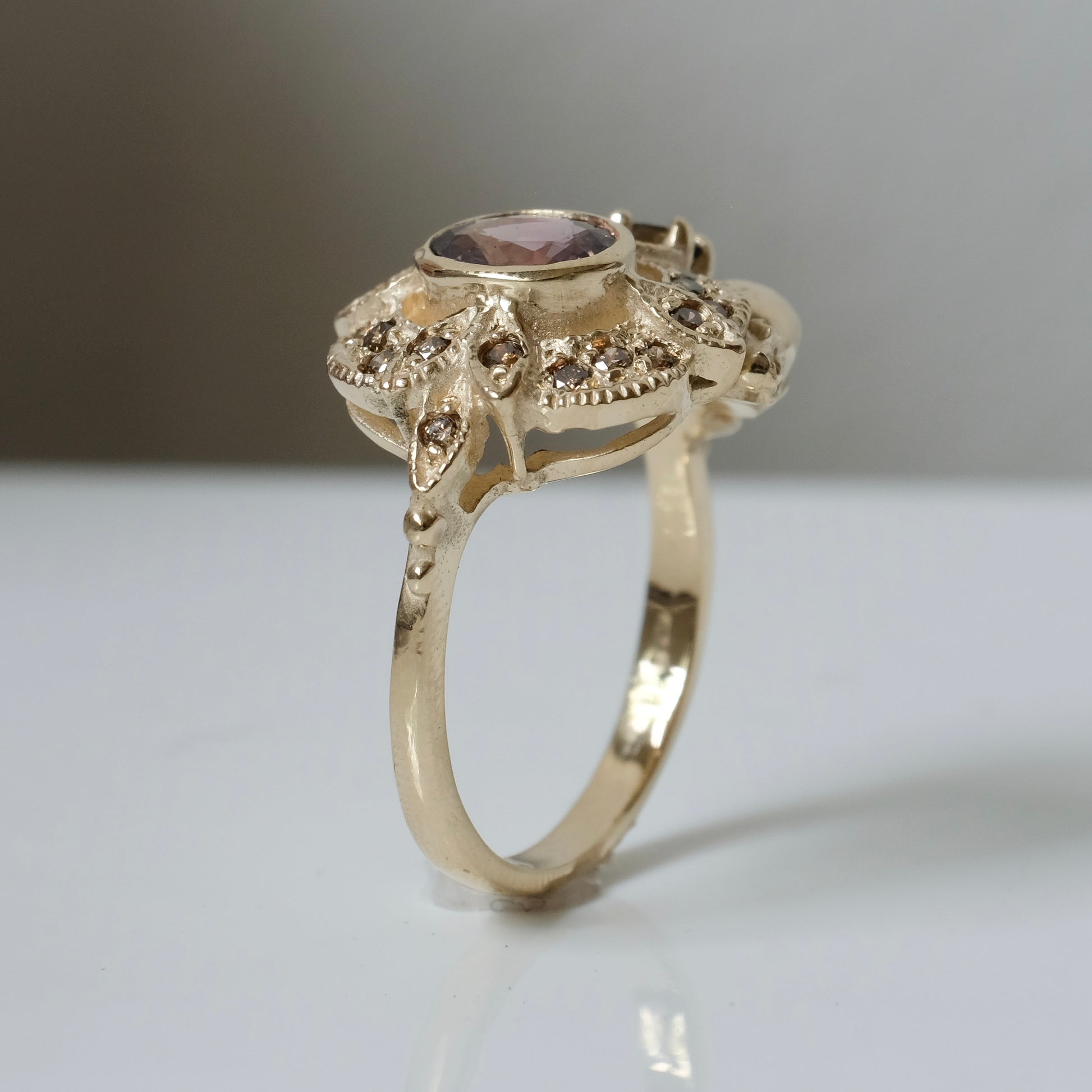The Helen engagement ring with colour change sapphire, champagne diamond with skulls and flowers made in 9ct yellow gold in London by Charlie Shires