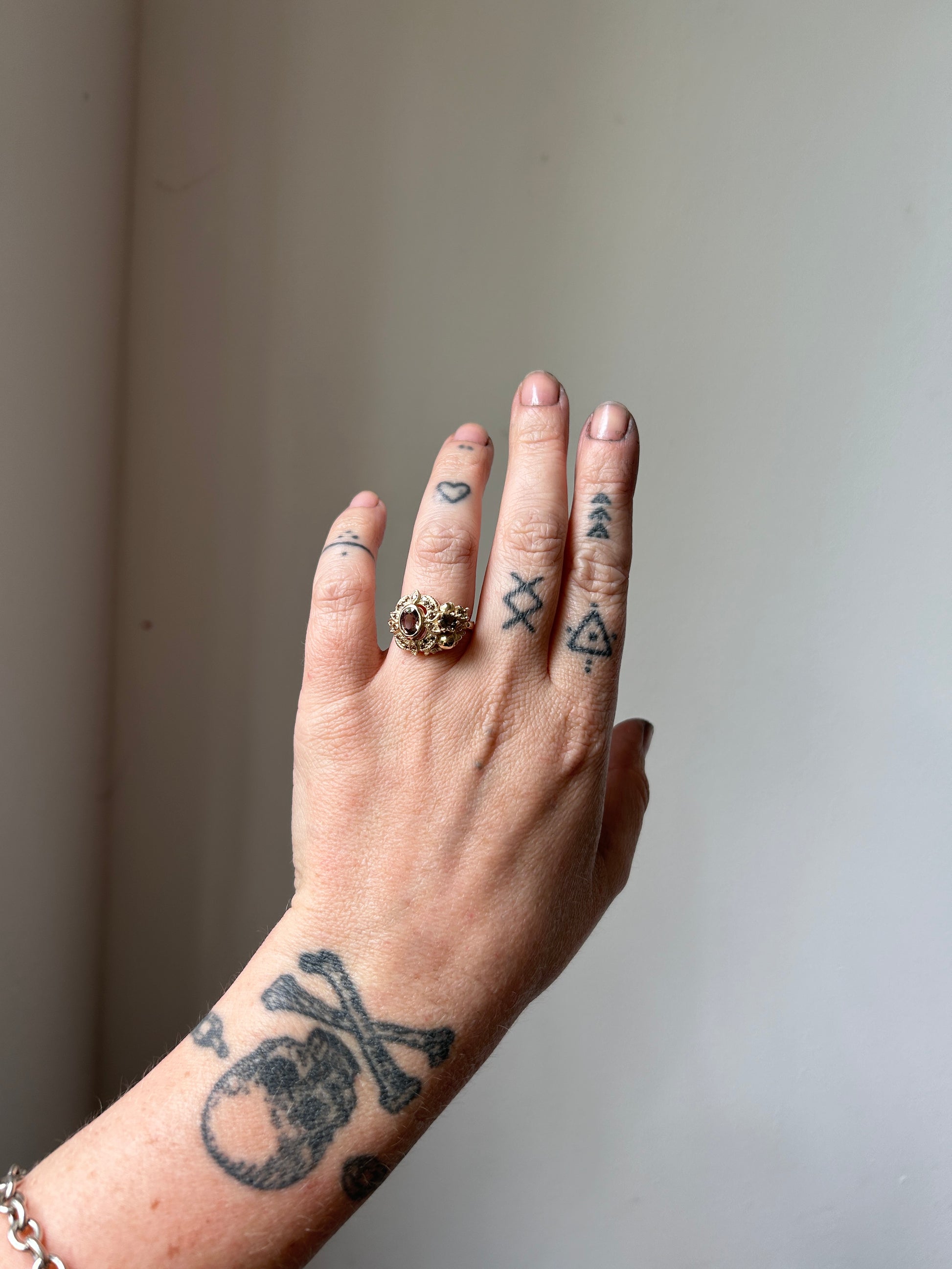 The Helen engagement ring with colour change sapphire, champagne diamond with skulls and flowers made in 9ct yellow gold in London by Charlie Shires