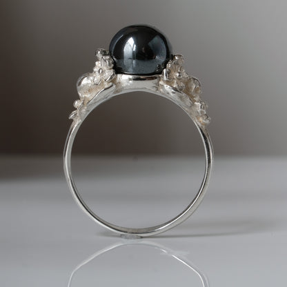 Silver skull and flower hematite ring by Charlie Shires