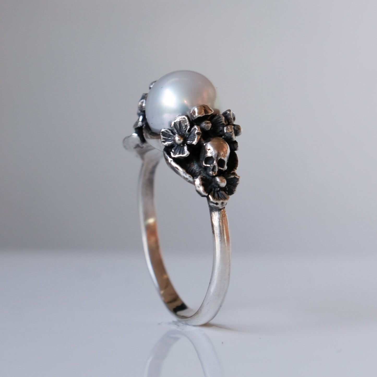 Sterling silver skull and flower pearl ring made in London by Charlie Shires