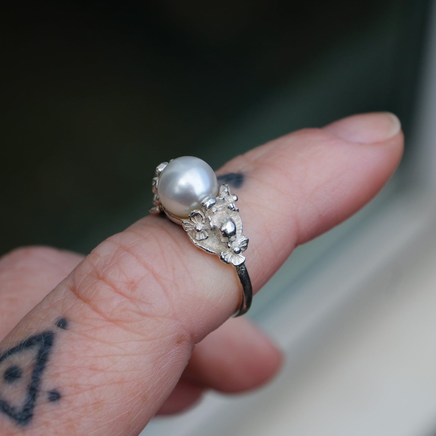 Sterling silver skull and flower pearl ring made in London by Charlie Shires