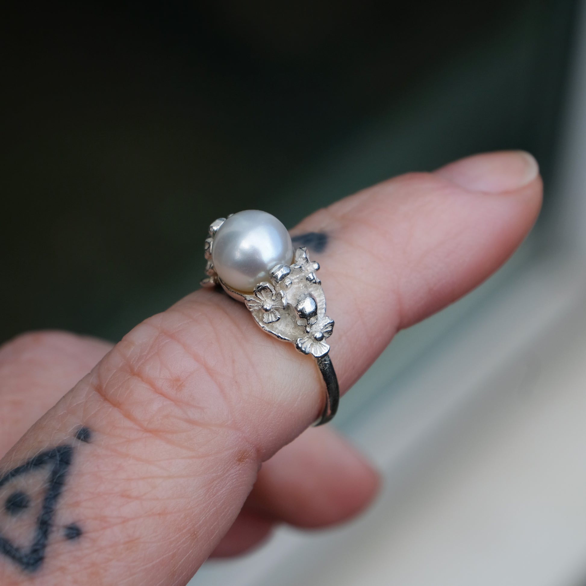 Sterling silver skull and flower pearl ring made in London by Charlie Shires