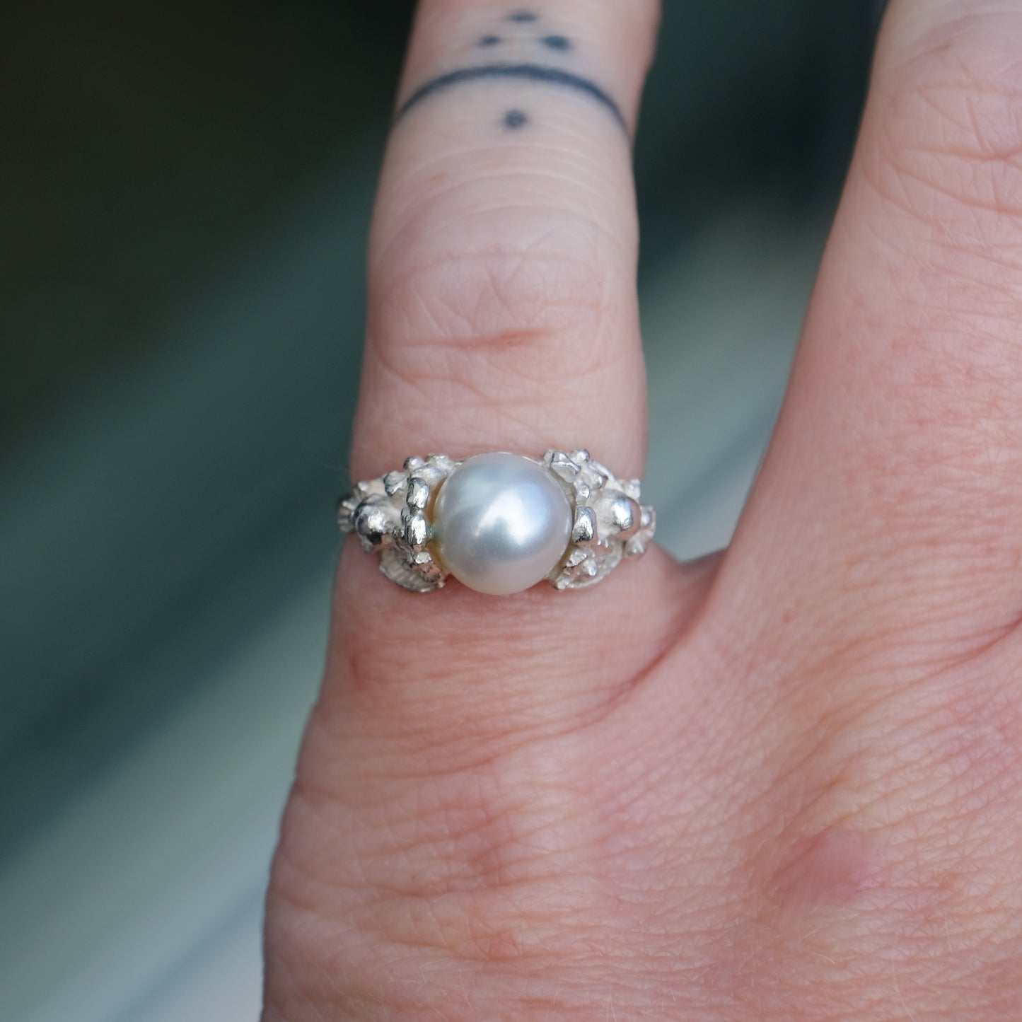 Sterling silver skull and flower pearl ring made in London by Charlie Shires