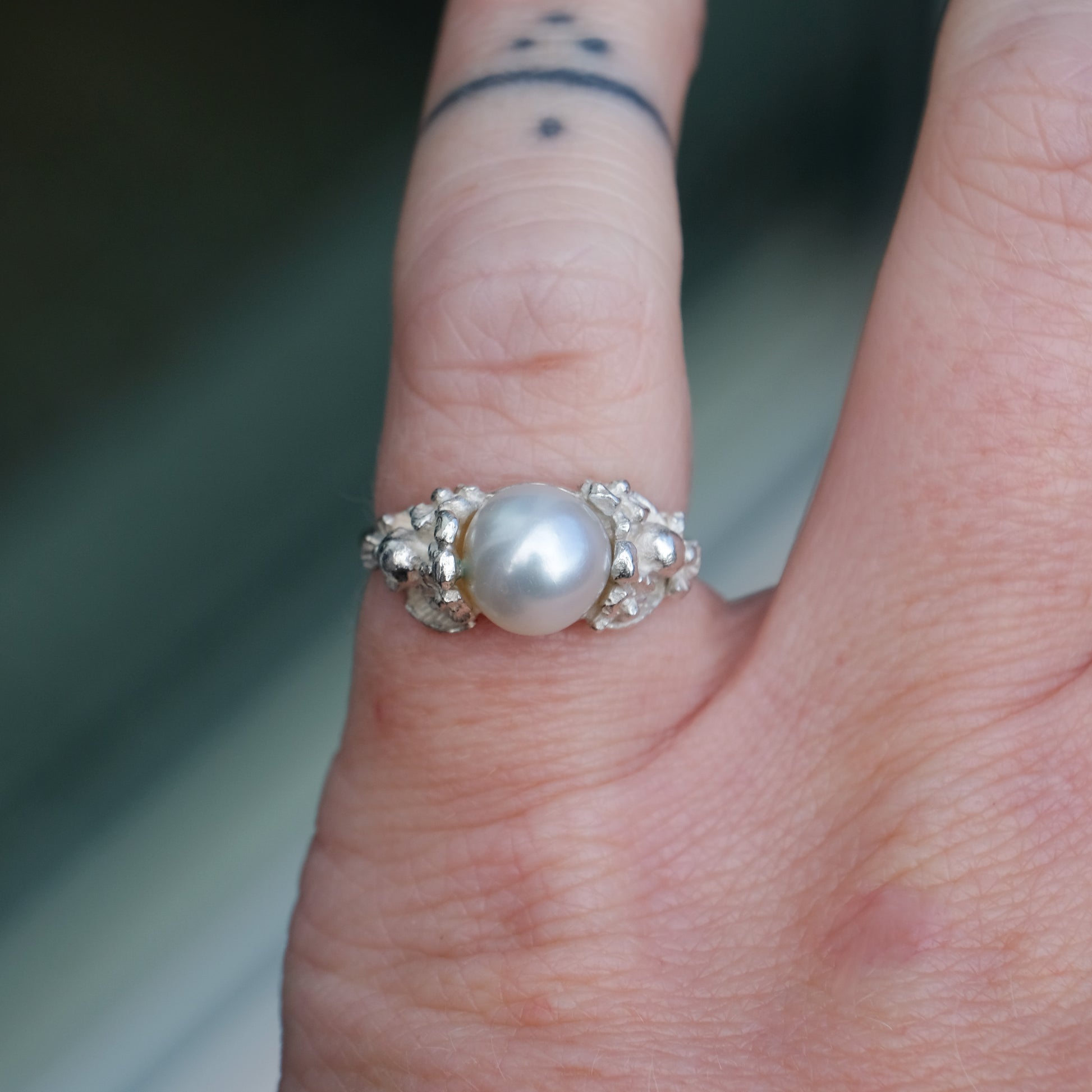 Sterling silver skull and flower pearl ring made in London by Charlie Shires