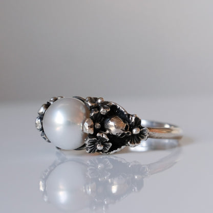 Sterling silver skull and flower pearl ring made in London by Charlie Shires