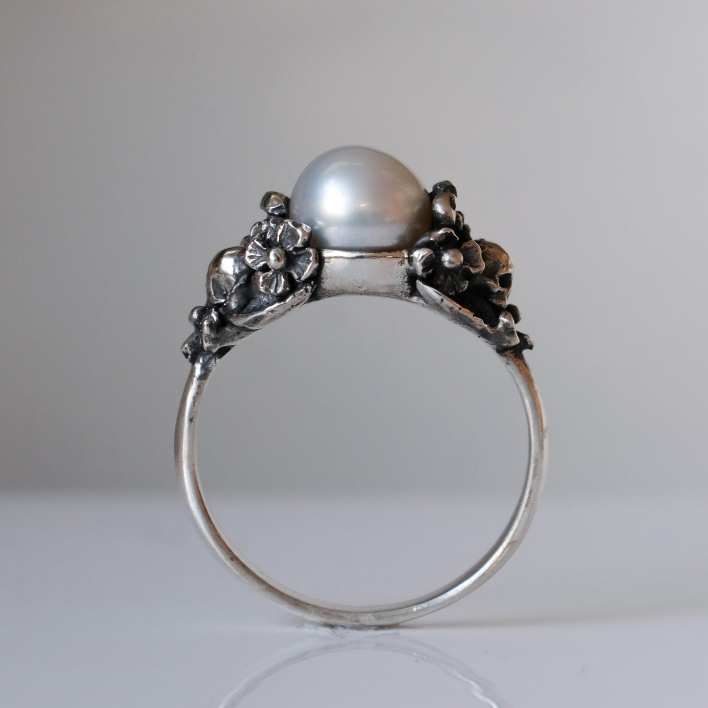 Sterling silver skull and flower pearl ring made in London by Charlie Shires