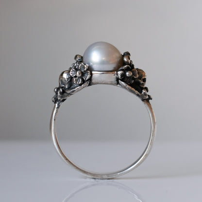 Sterling silver skull and flower pearl ring made in London by Charlie Shires