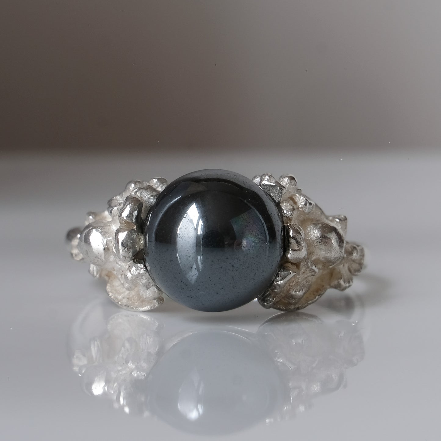 Silver skull and flower hematite ring by Charlie Shires