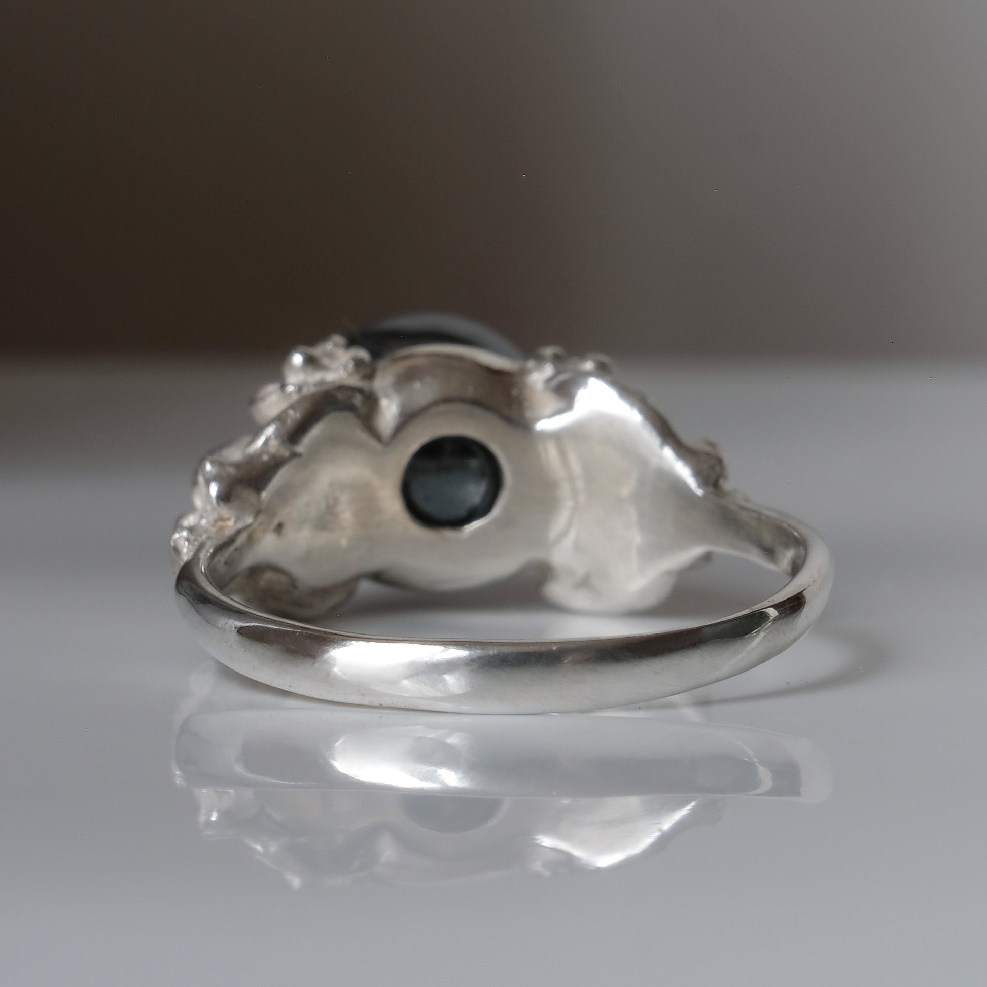 Silver skull and flower hematite ring by Charlie Shires