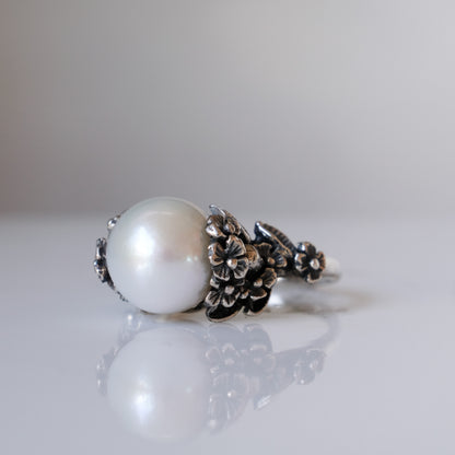 Large pearl ring with flower and skull motif down band. made in sterling silver in London by Charlie Shires