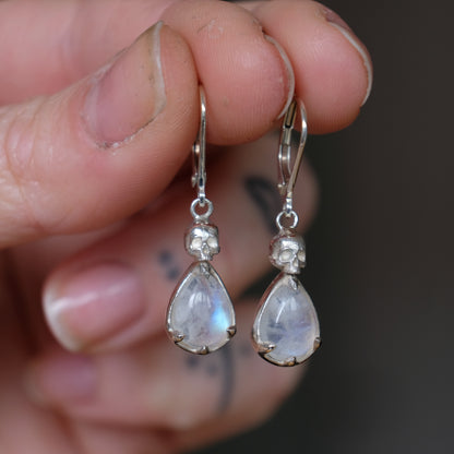 Skull earrings with claw set pear shaped moonstones made in sterling silver by Charlie Shires