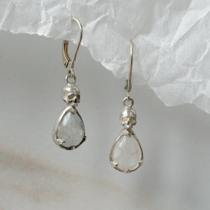 Skull earrings with claw set pear shaped moonstones made in sterling silver by Charlie Shires
