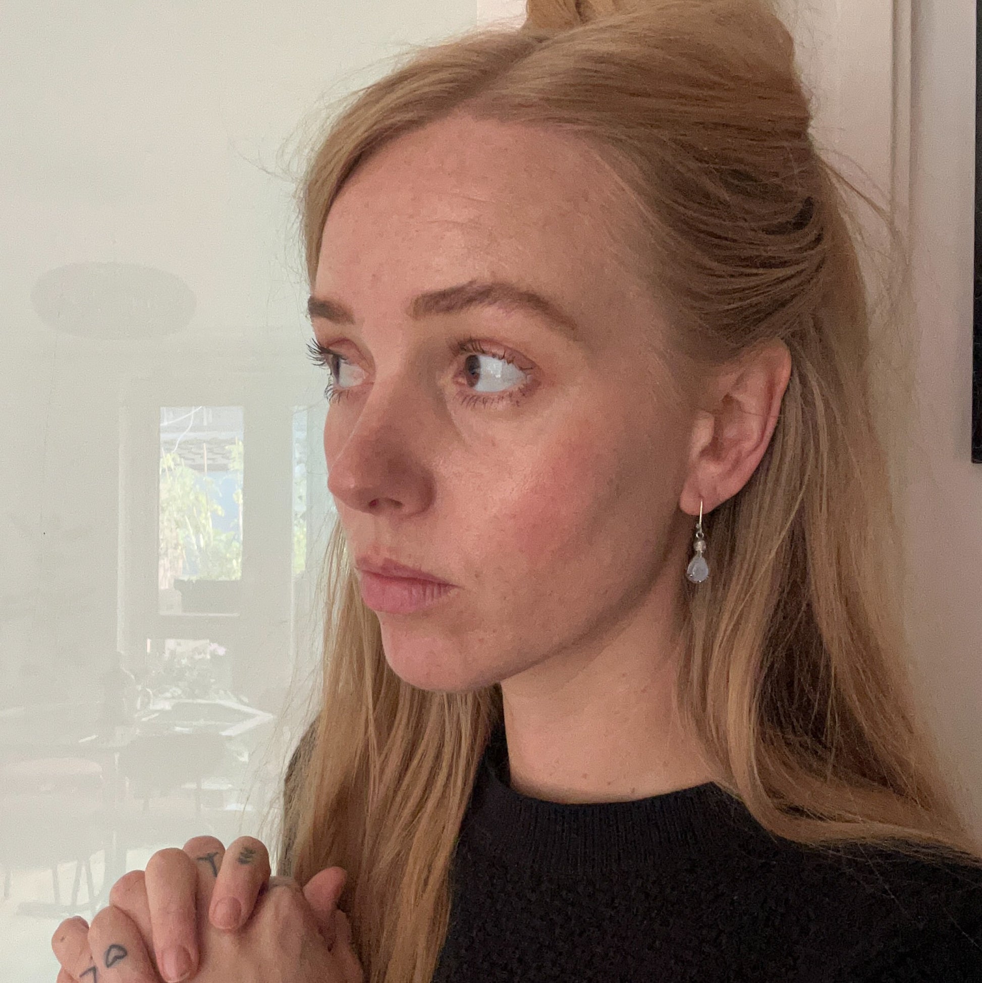 Skull earrings with claw set pear shaped moonstones made in sterling silver by Charlie Shires