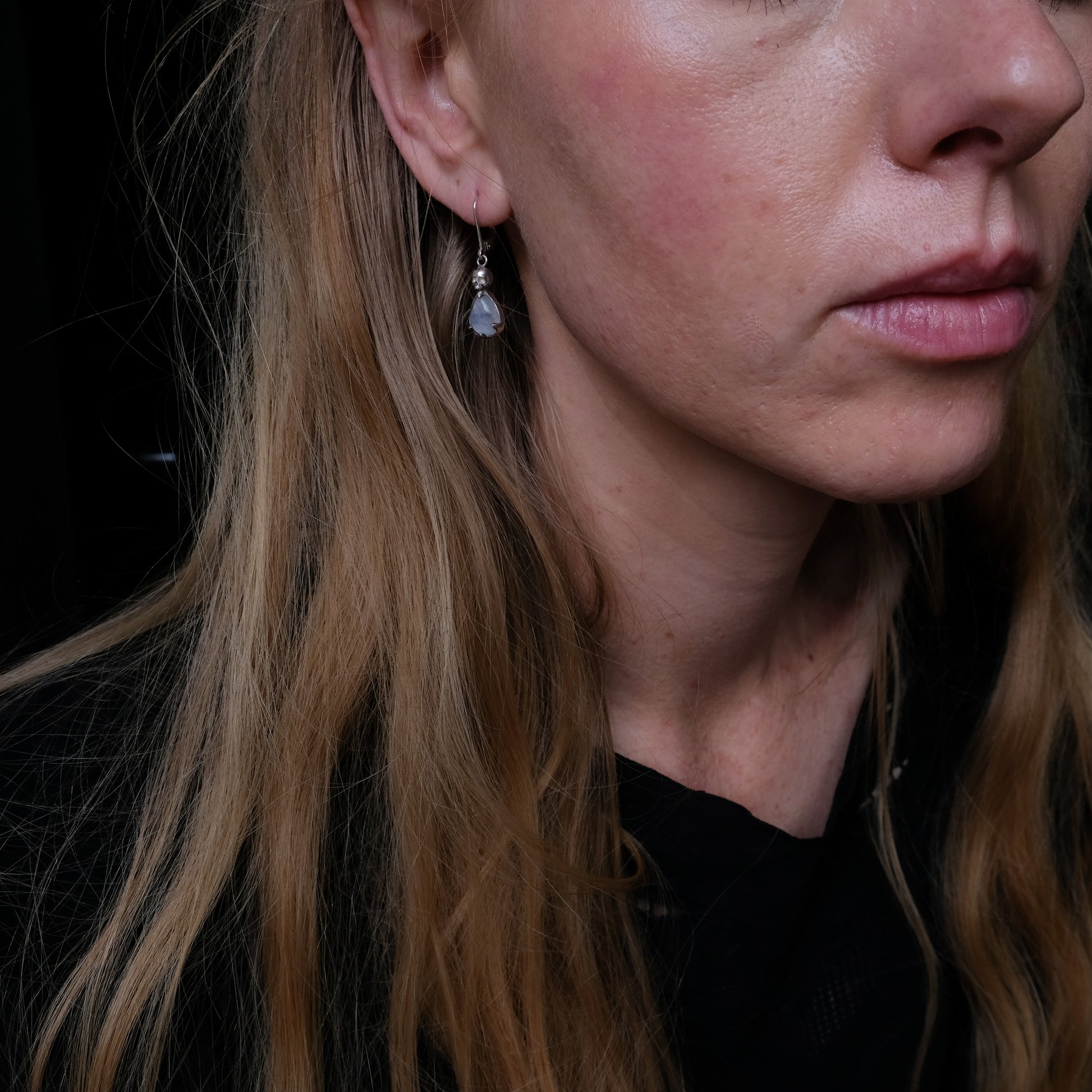 Skull earrings with claw set pear shaped moonstones made in sterling silver by Charlie Shires