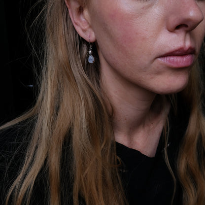 Skull earrings with claw set pear shaped moonstones made in sterling silver by Charlie Shires