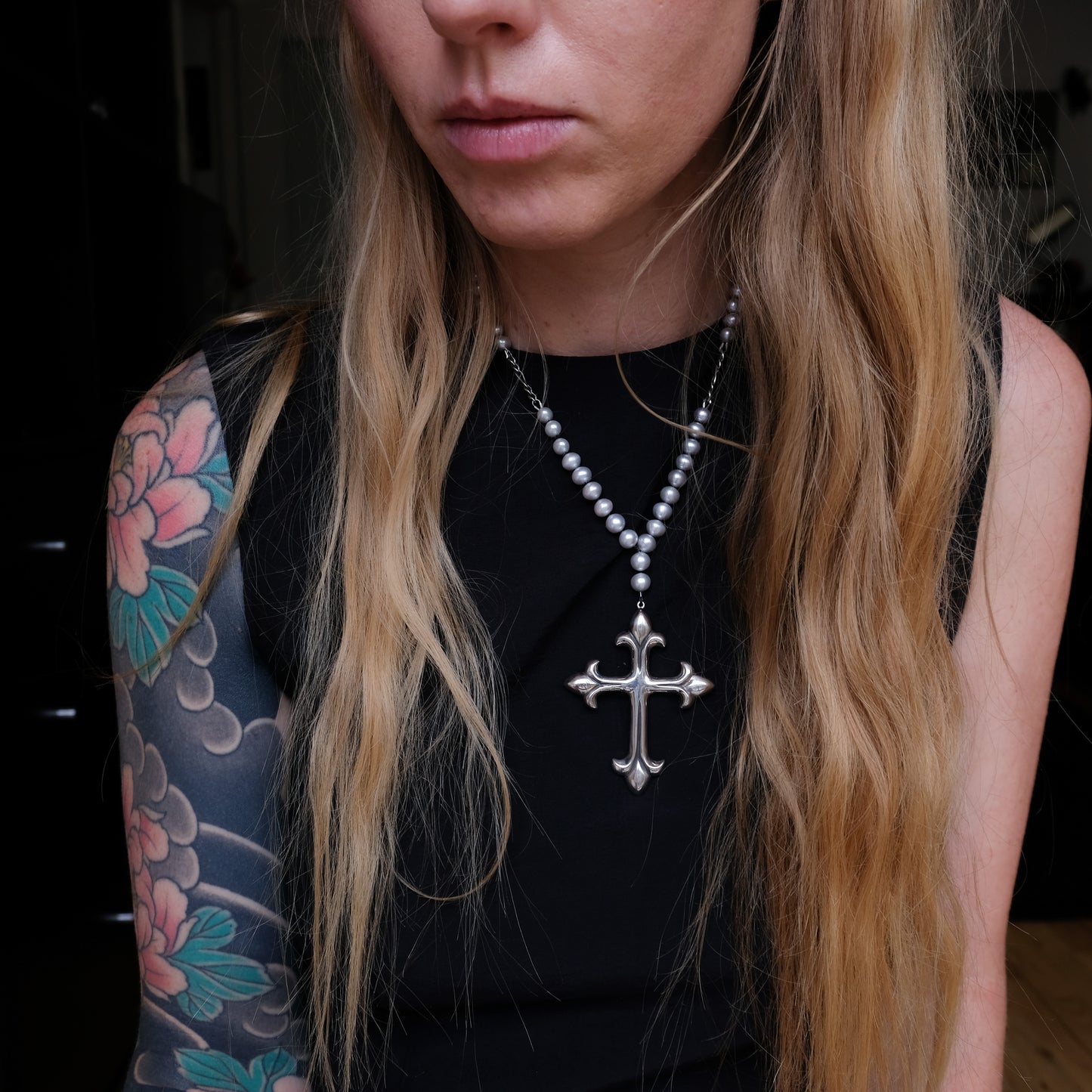 Large crucifix hand strung on a pearl chain. Crucifix is made of Sterling silver by Charlie Shires