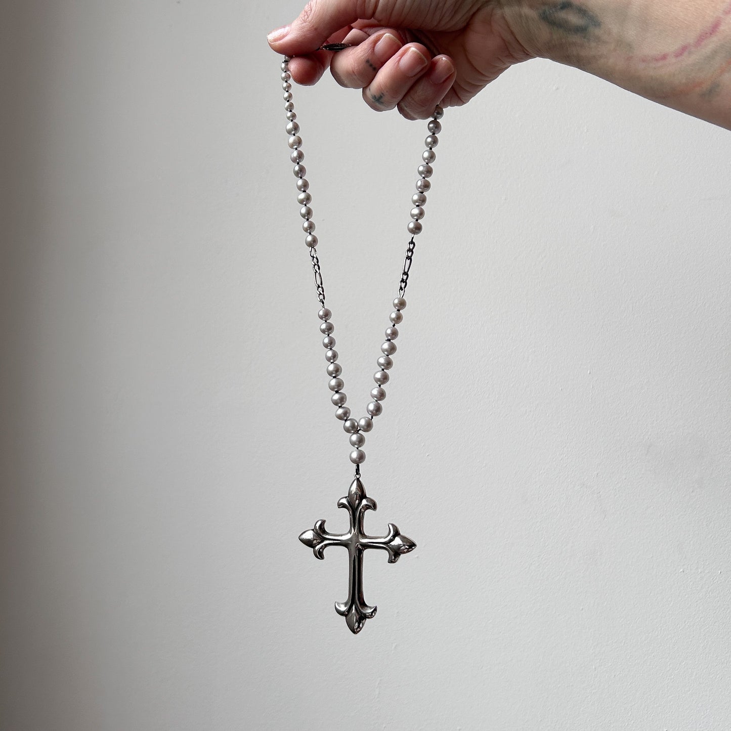 Large crucifix hand strung on a pearl chain. Crucifix is made of Sterling silver by Charlie Shires