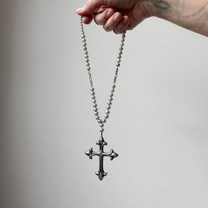 Large crucifix hand strung on a pearl chain. Crucifix is made of Sterling silver by Charlie Shires