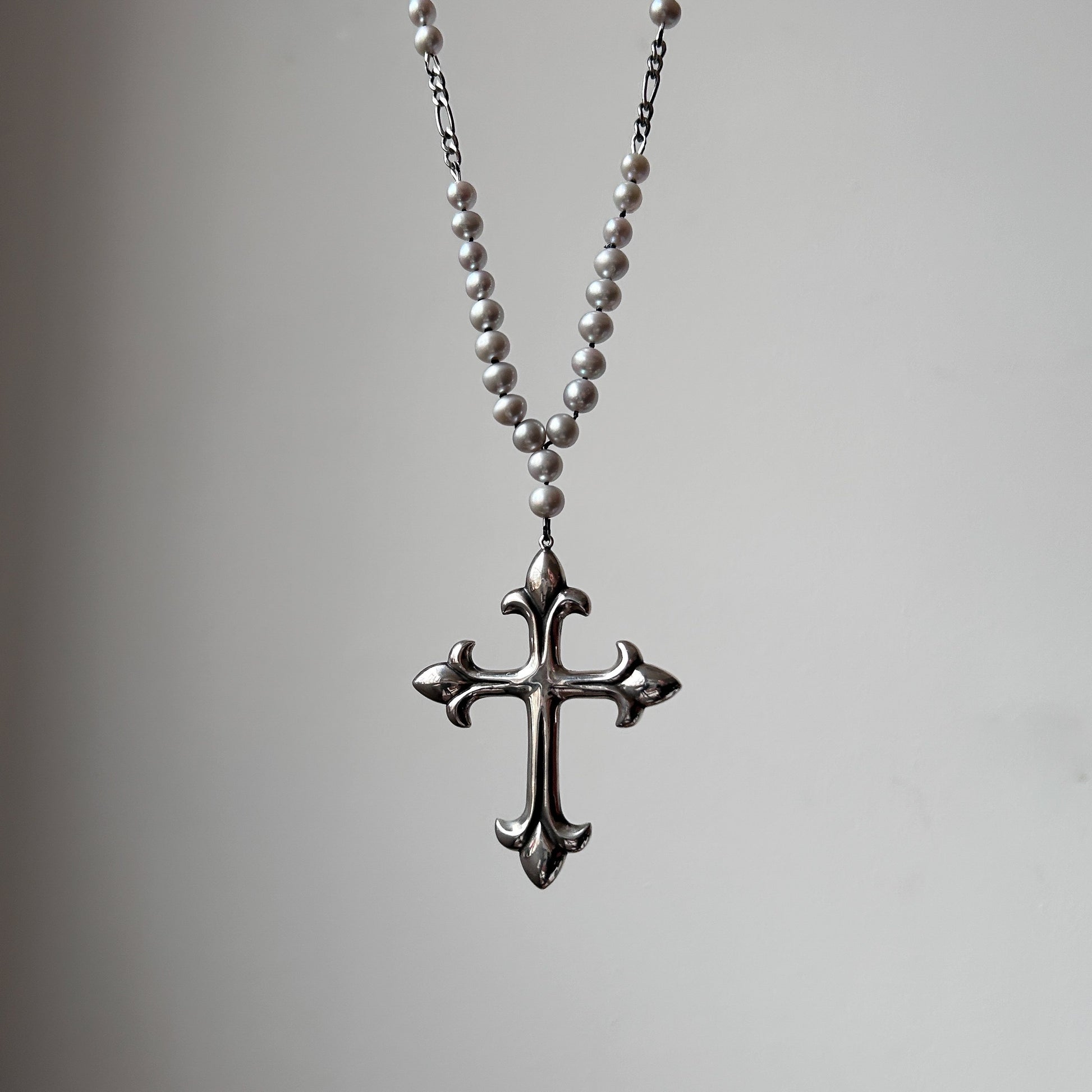 Large crucifix hand strung on a pearl chain. Crucifix is made of Sterling silver by Charlie Shires