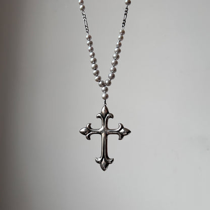 Large crucifix hand strung on a pearl chain. Crucifix is made of Sterling silver by Charlie Shires