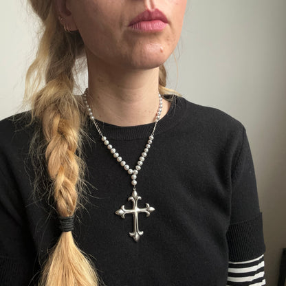 Large crucifix hand strung on a pearl chain. Crucifix is made of Sterling silver by Charlie Shires