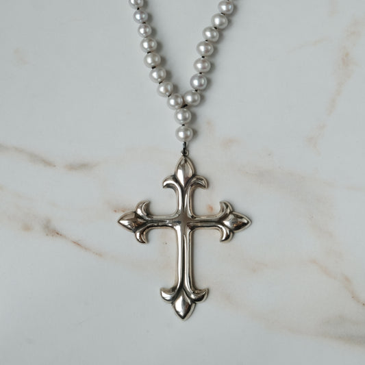 Large crucifix hand strung on a pearl chain. Crucifix is made of Sterling silver by Charlie Shires