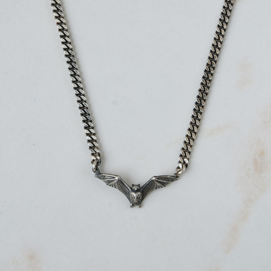 Bat necklace on curb link chain, made in sterling silver by Charlie Shires in London