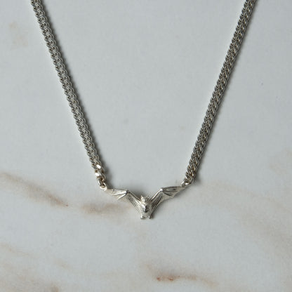 Bat necklace on curb link chain, made in sterling silver by Charlie Shires in London