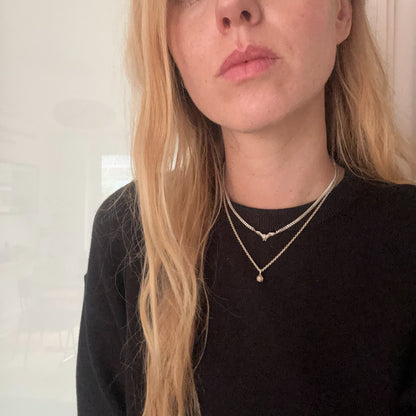 Sterling silver bat necklace stacked with small skull necklace, handmade in London by Charlie Shires