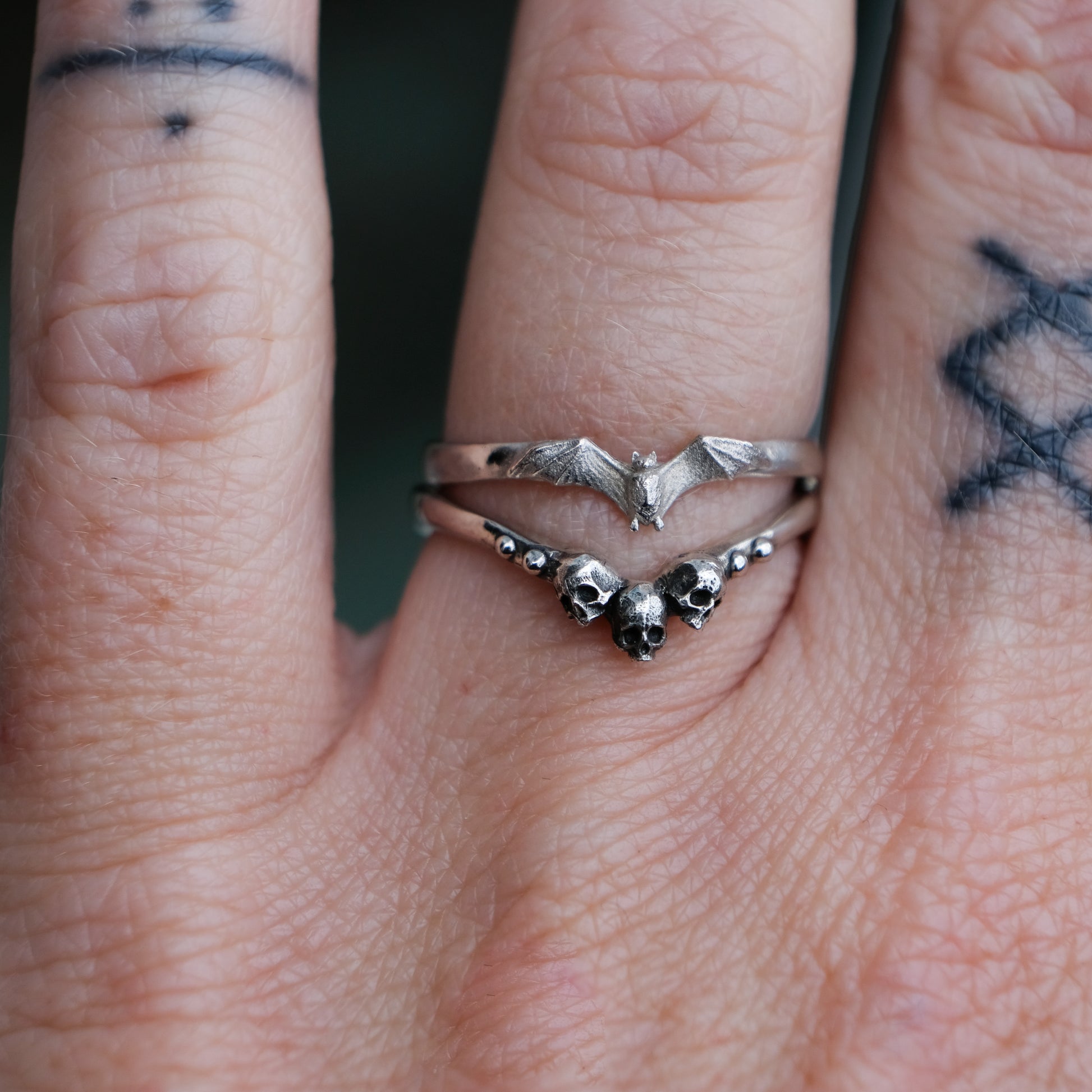 small sterling silver bat ring stacked with Gilda skull stack ring by Charlie Shires in London