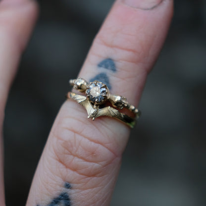 Mina bat ring in 9ct yellow gold stacked with diamond skull solitaire ring. Handmade in London by Charlie Shires