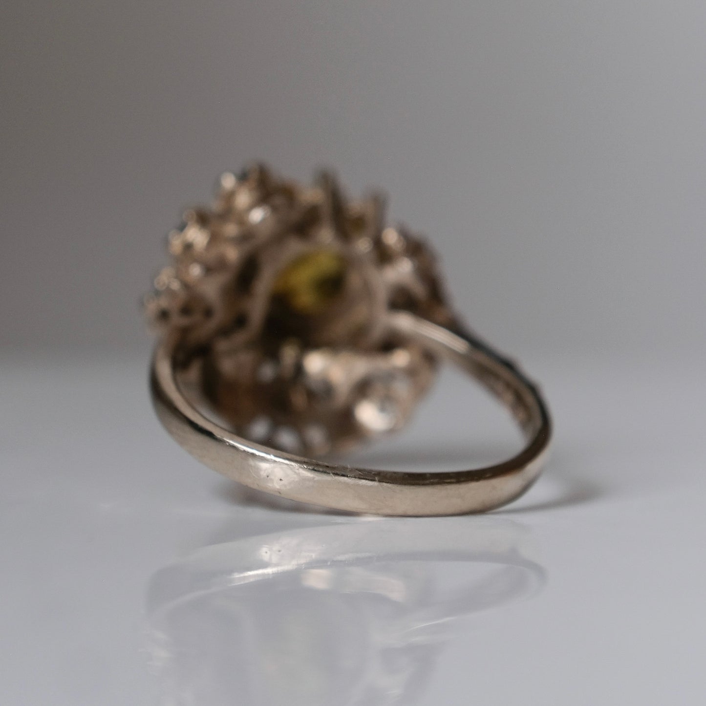 Salacia engagement ring with central Sphene and sapphire halo, salt and pepper diamonds, skulls and flowers. Made in 14ct white gold in London by Charlie Shires