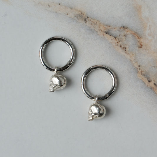 Sterling silver skull huggie hoop earrings made in London by Charlie Shires