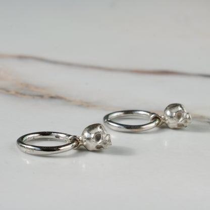 Sterling silver skull huggie hoop earrings made in London by Charlie Shires