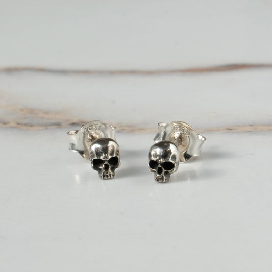 Small skull studs made in sterling silver in London by Charlie Shires