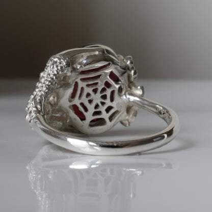 Silver birds talon claw ring with garnet stones by Charlie Shires