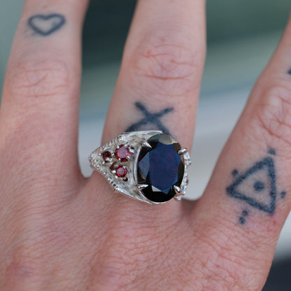 Silver birds talon claw ring with garnet stones by Charlie Shires