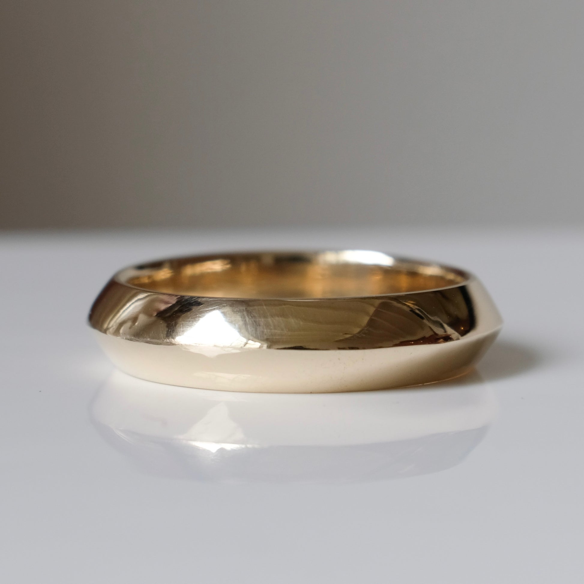 Knife edge gold mens wedding band. 9ct yellow gold, handmade in London by Charlie Shires