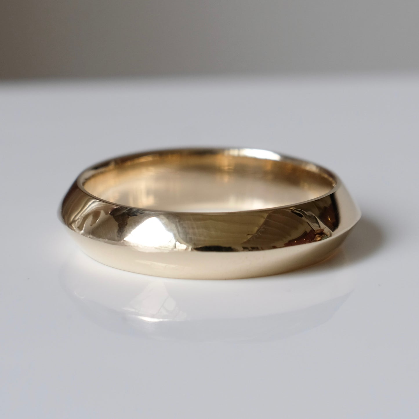Knife edge gold mens wedding band. 9ct yellow gold, handmade in London by Charlie Shires