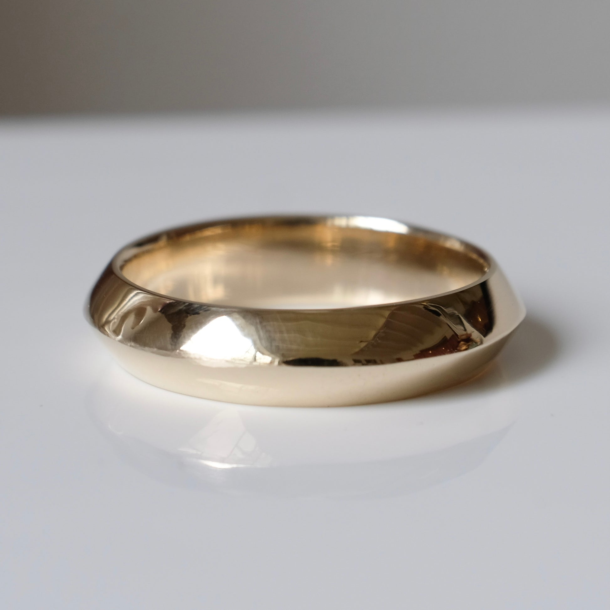 Knife edge gold mens wedding band. 9ct yellow gold, handmade in London by Charlie Shires