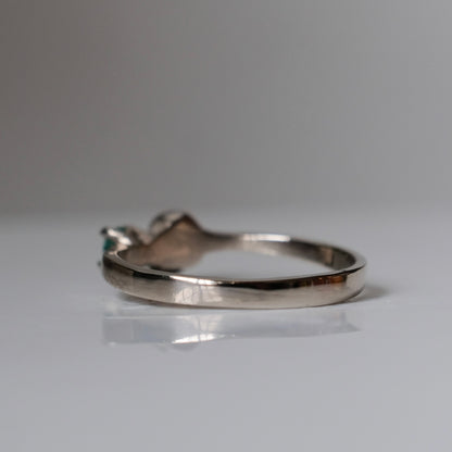 14ct white gold engagement ring with skull and emerald claw set stone. Handmade in London by Charlie Shires