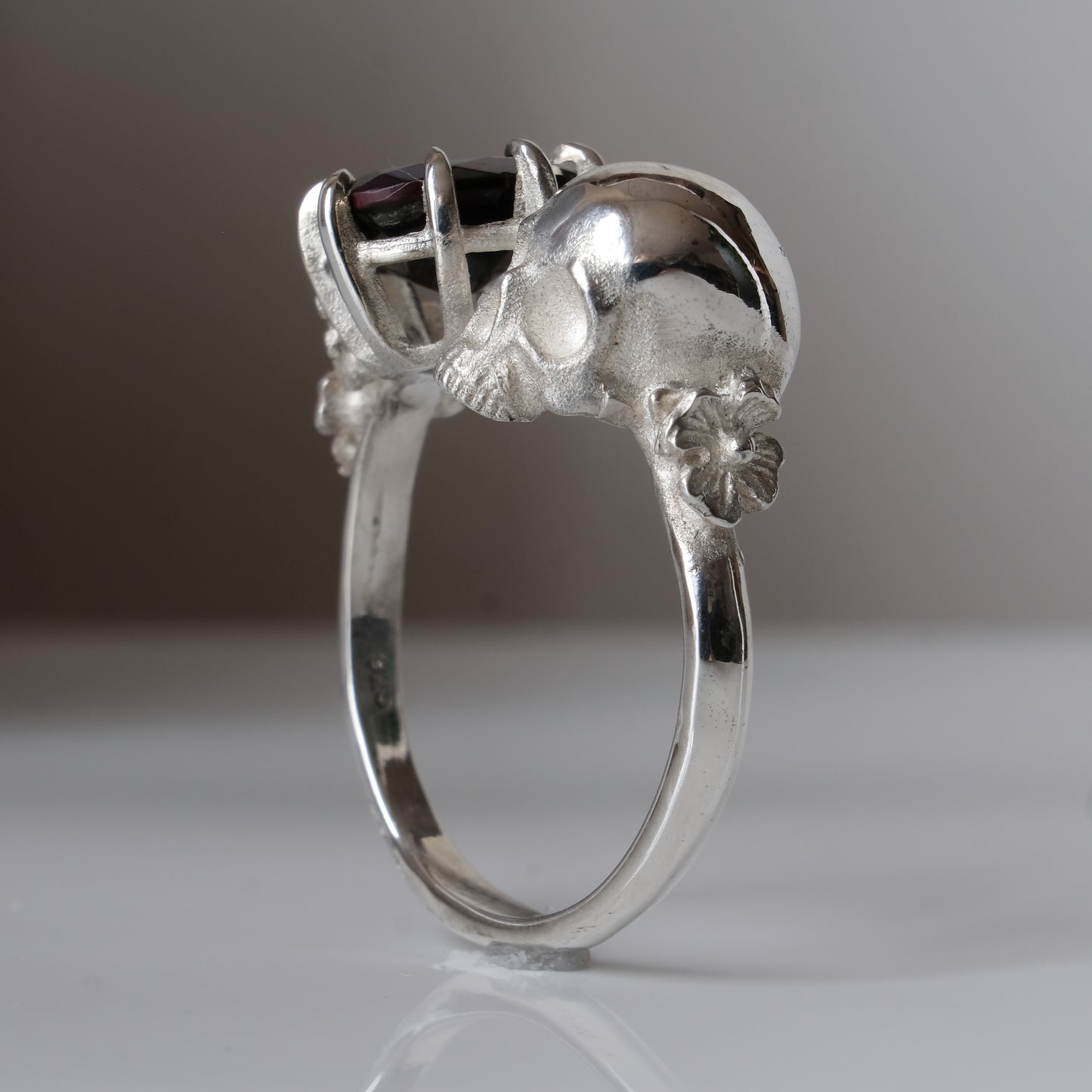Silver skull and black opal ring with decorative flowers by Charlie Shires jewellery