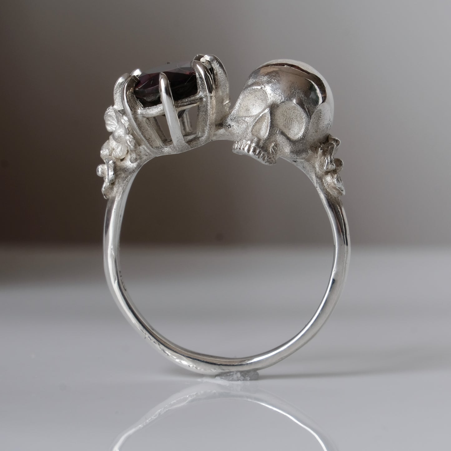 Silver skull and black opal ring with decorative flowers by Charlie Shires jewellery