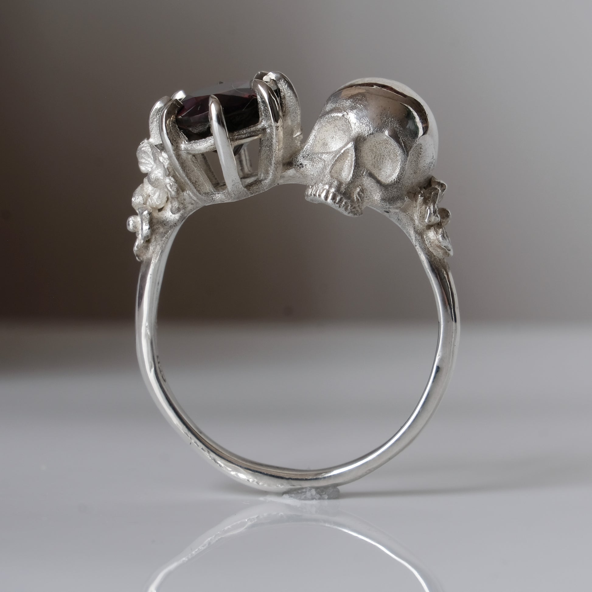 Silver skull and black opal ring with decorative flowers by Charlie Shires jewellery