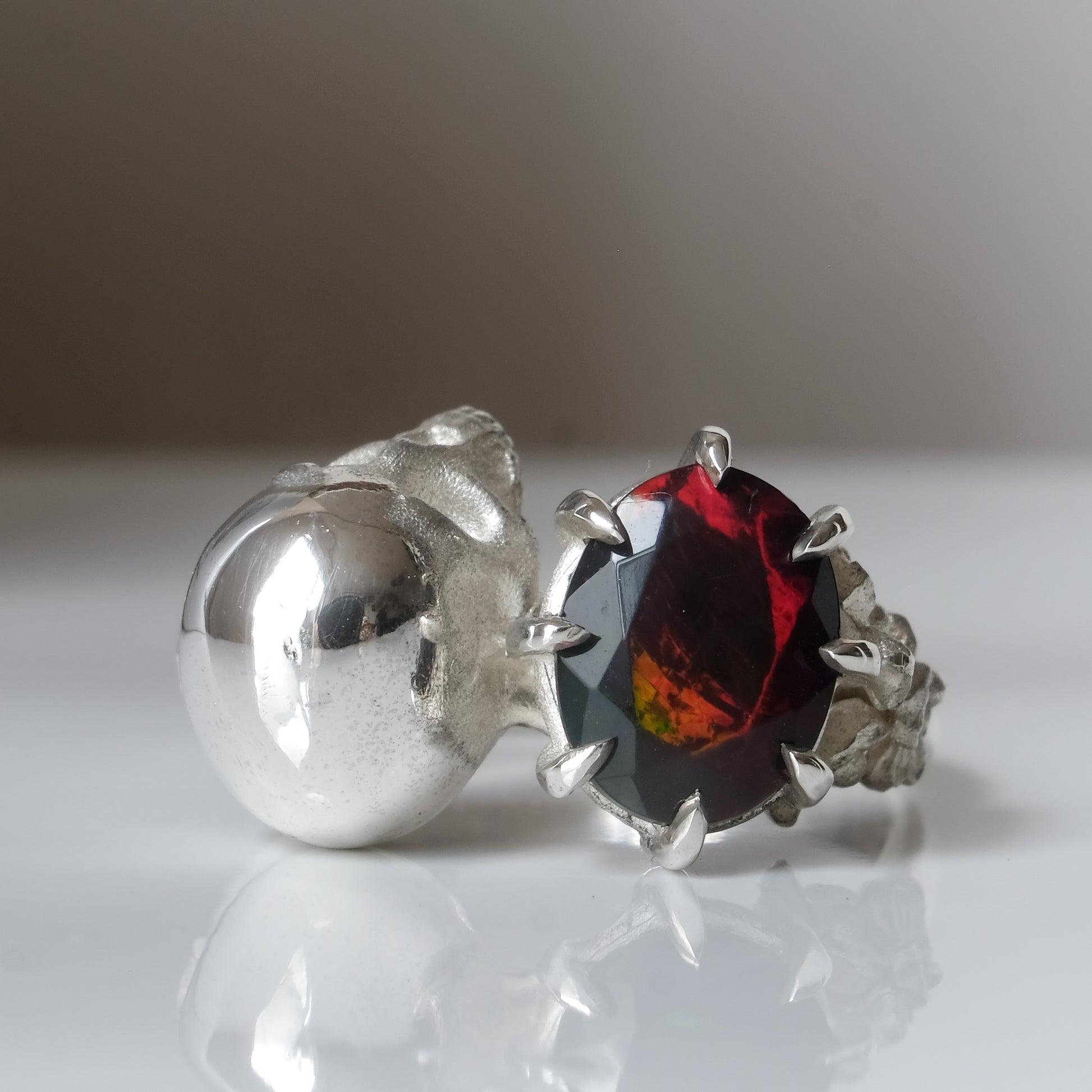 Silver skull and black opal ring with decorative flowers by Charlie Shires jewellery
