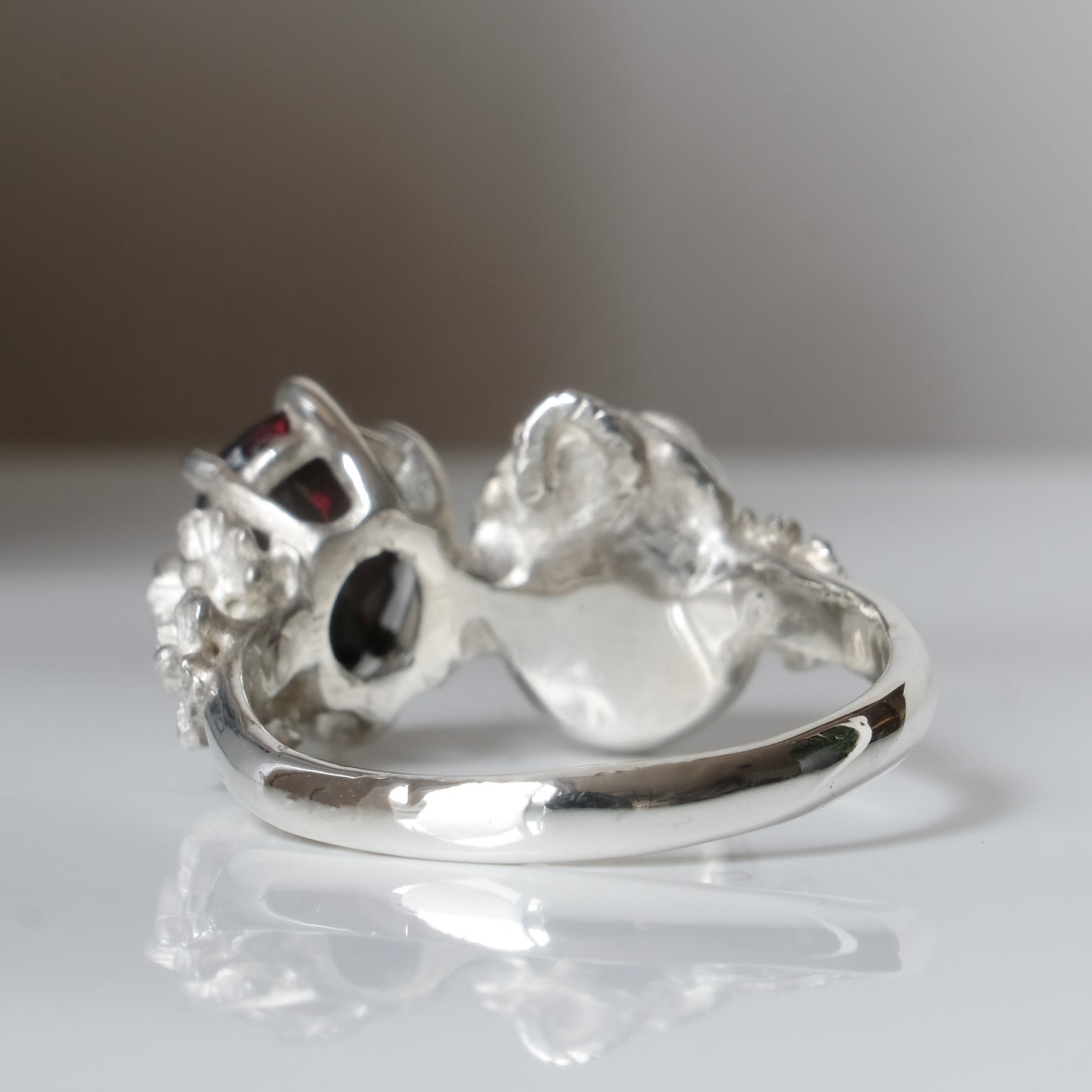 Silver skull and black opal ring with decorative flowers by Charlie Shires jewellery