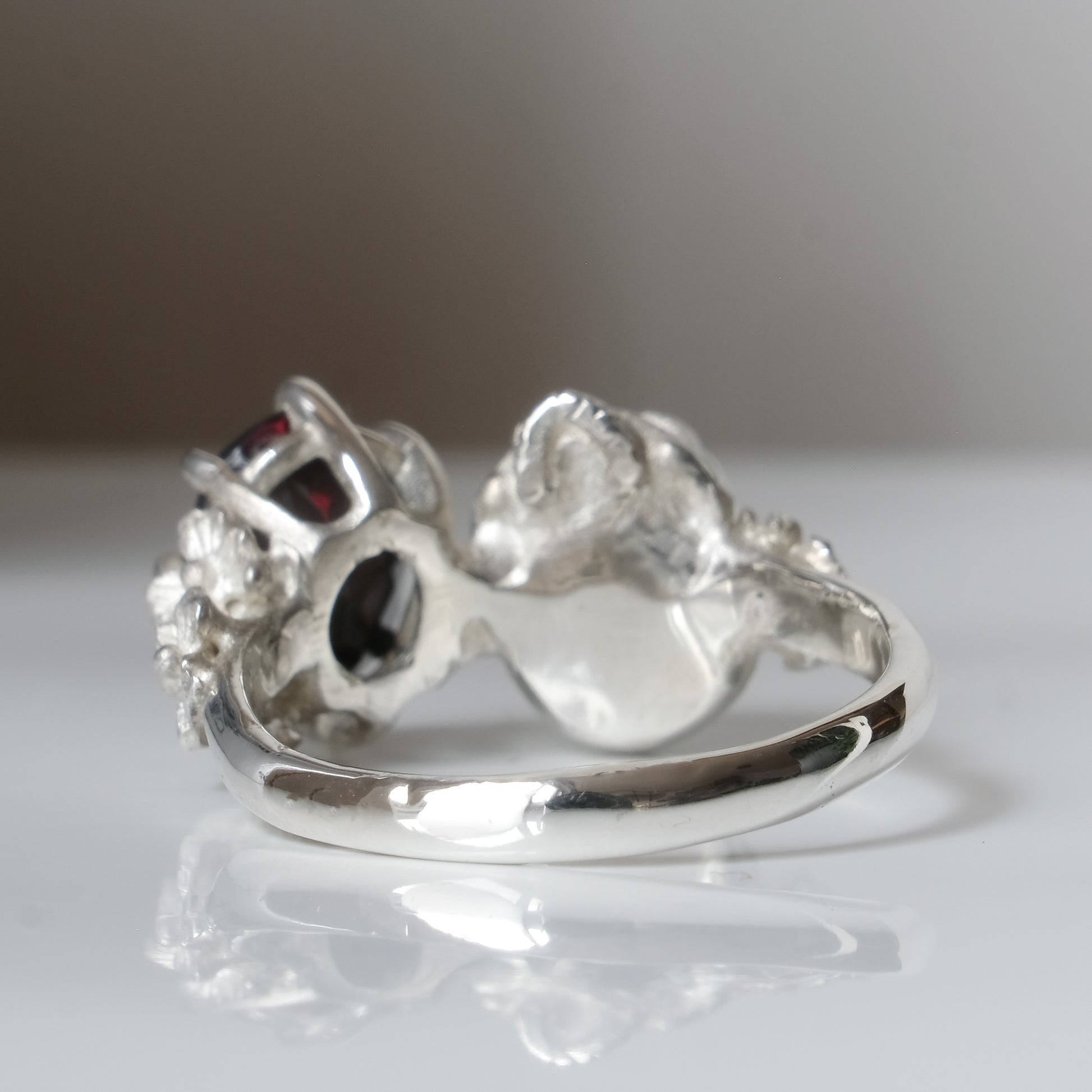 Silver skull and black opal ring with decorative flowers by Charlie Shires jewellery